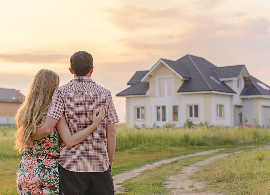 Couple Looking at their New House — Outback Conveyancing Services in Alice Springs, NT	