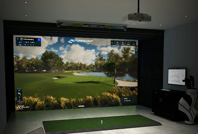 A golf simulator with a large screen displaying a golf course.
