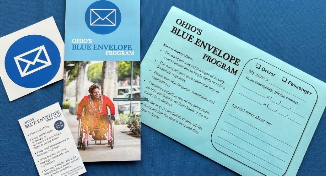 Pictured: a photo of the Blue Envelope Package which includes a car decal, wallet card, brochure