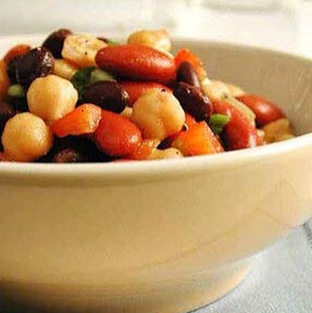 Bowl of mixed beans and vegetables in a cream-colored bowl.