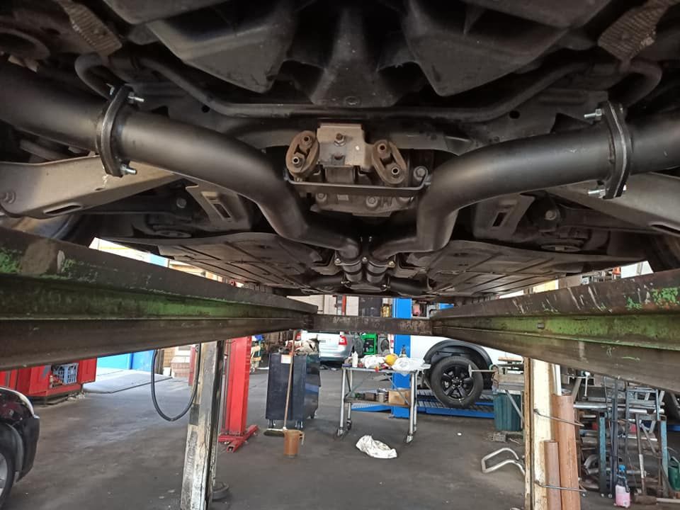 A Car Is Sitting On A Lift In A Garage — Coughrans Auto Centre  In Toowoomba, QLD