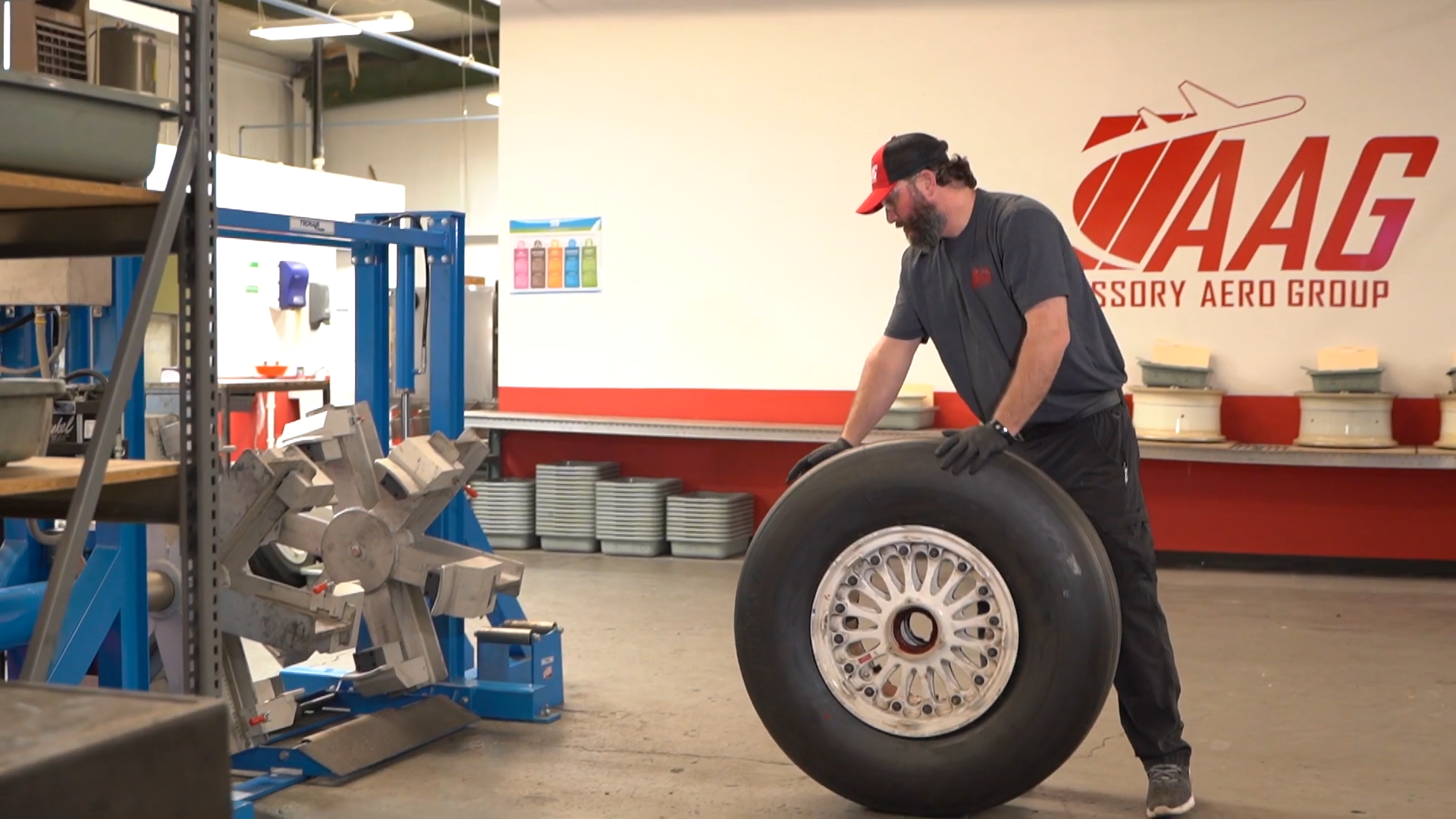Man lifting plane tire in workshop - Nashville, Tennessee | JetRight Aerospace Holdings