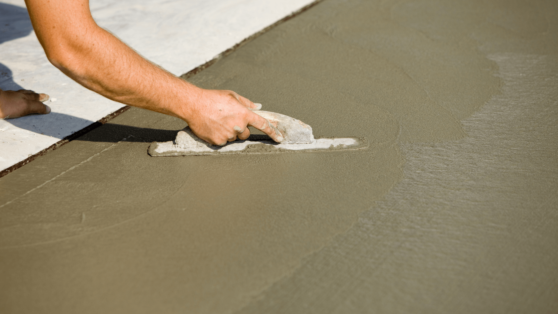 Concrete company smooths out a newly poured driveway in Houston, TX