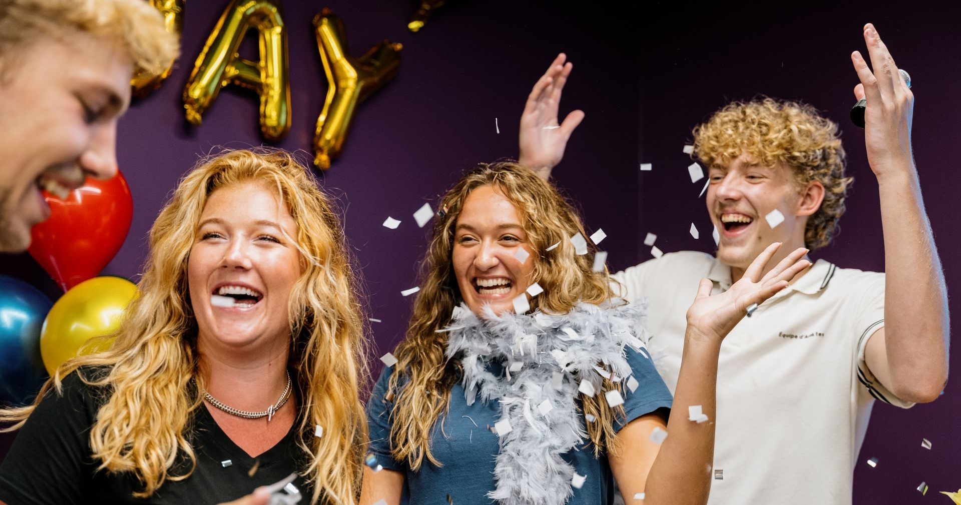 A group of people are standing next to each other at a birthday party.