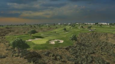 An aerial view of a golf course in the middle of a desert.