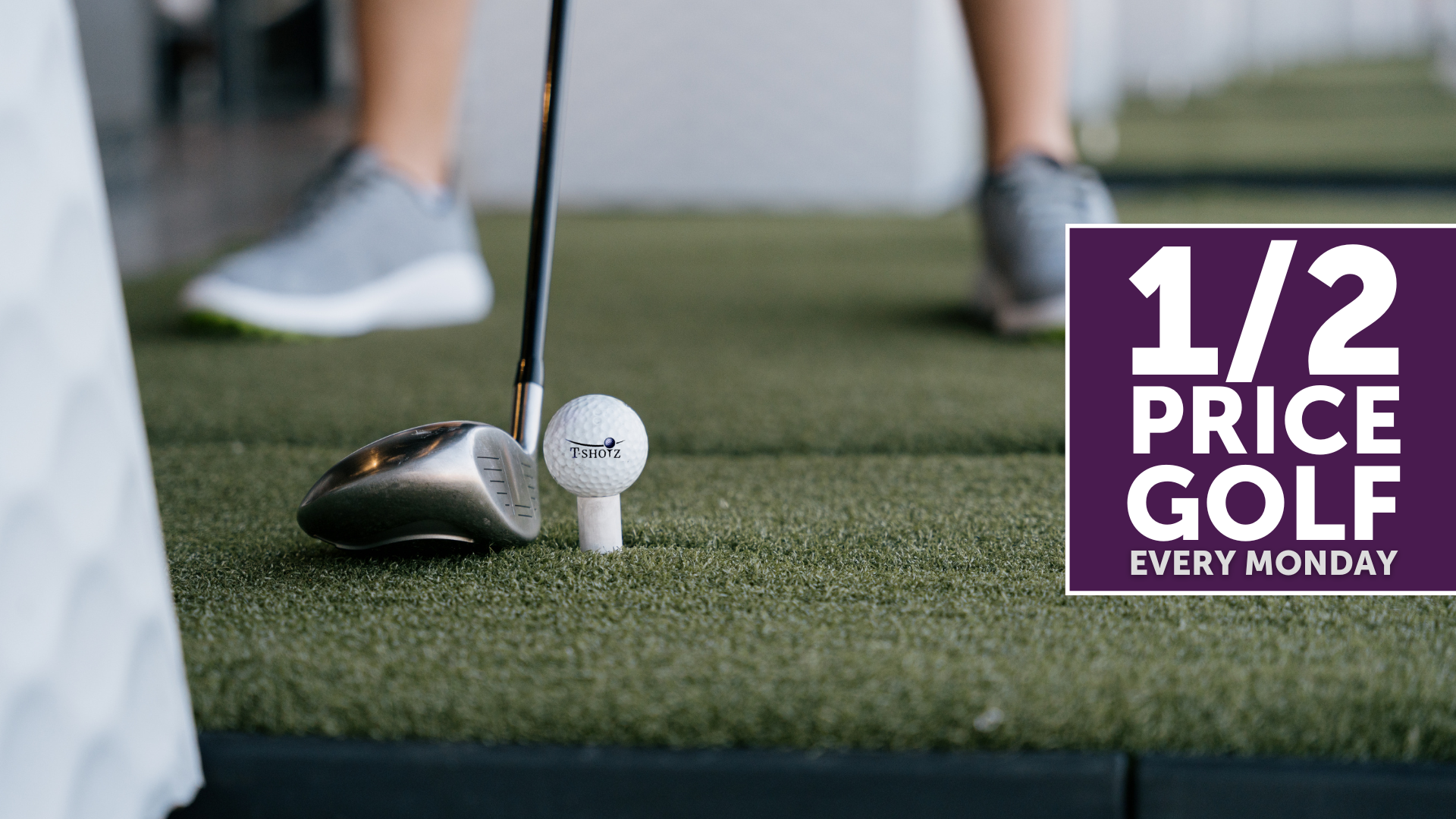 A person is playing golf on a green with a sign that says 1/2 price golf every monday.