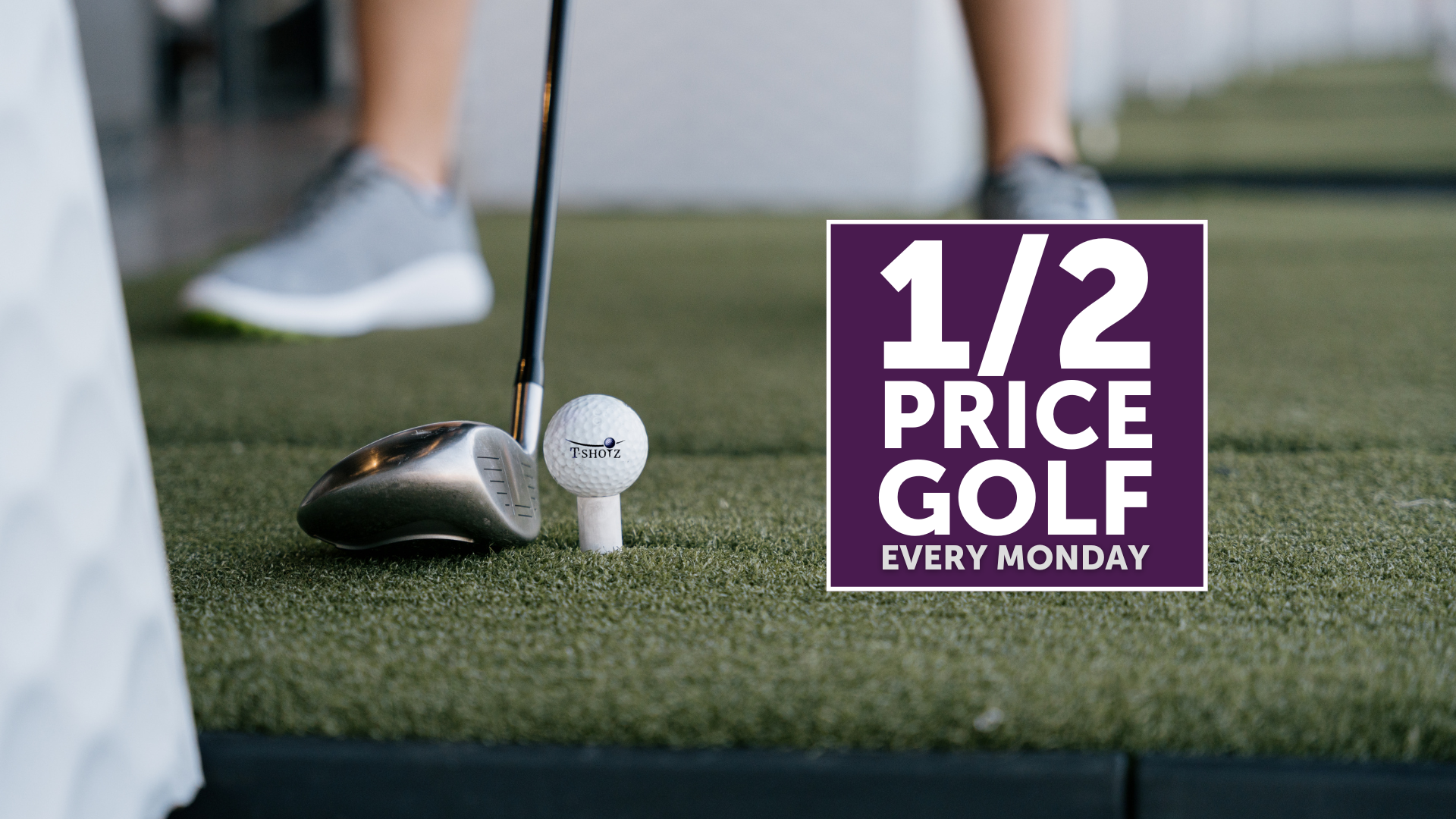A person is playing golf with a sign that says 1/2 price golf every monday.