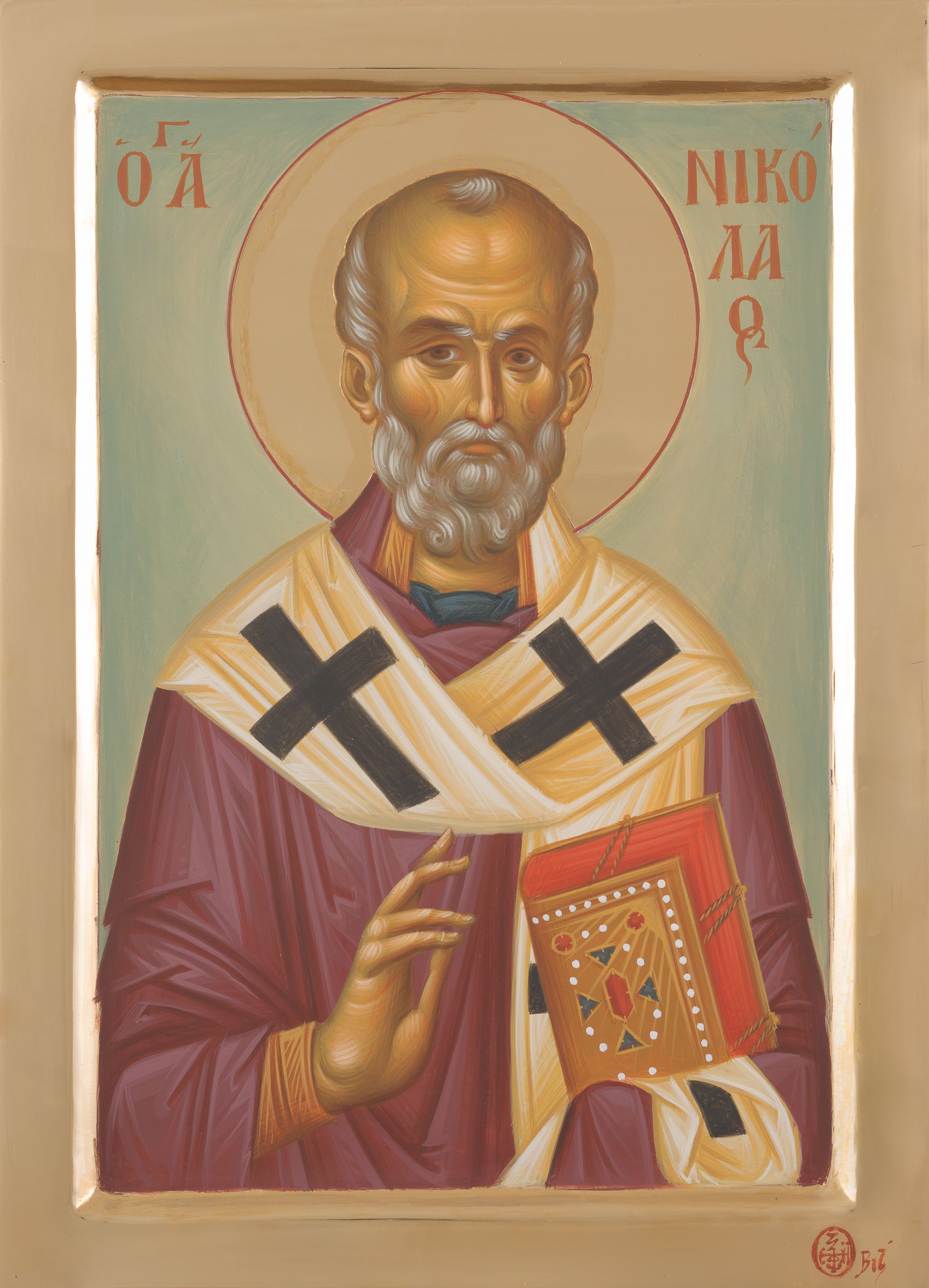 Orthodox icon of a bearded saint with halo, holding a book and blessing gesture, in red and gold robes