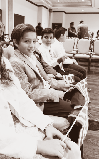 Click on name below for more information People seated in a conference room, looking toward the camera.