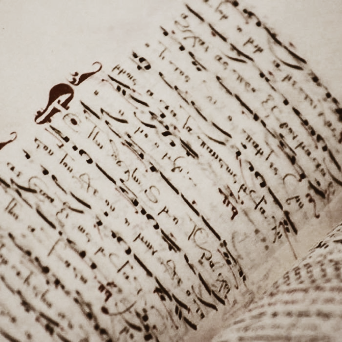 Close-up of aged handwritten manuscript pages with dark ink and decorative script