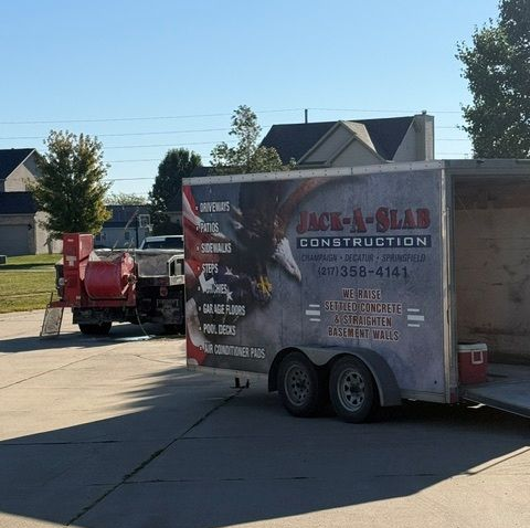 Construction trailer and red equipment parked on a sunny suburban street Construction trailer and red equipment parked on a sunny suburban street