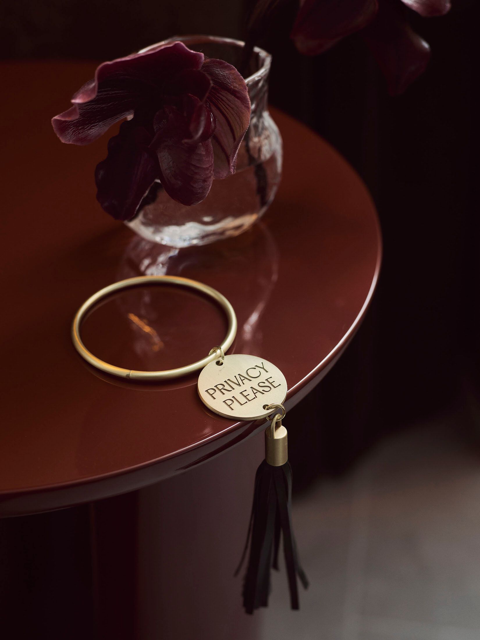 EVE Hotel “Privacy Please” door hanger with tassel on a door