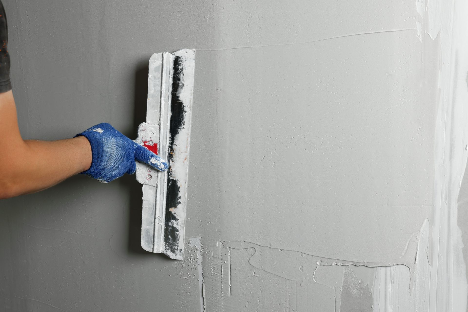 Close-up of a smooth drywall patch blended into a surrounding wall in an Orlando, FL home.
