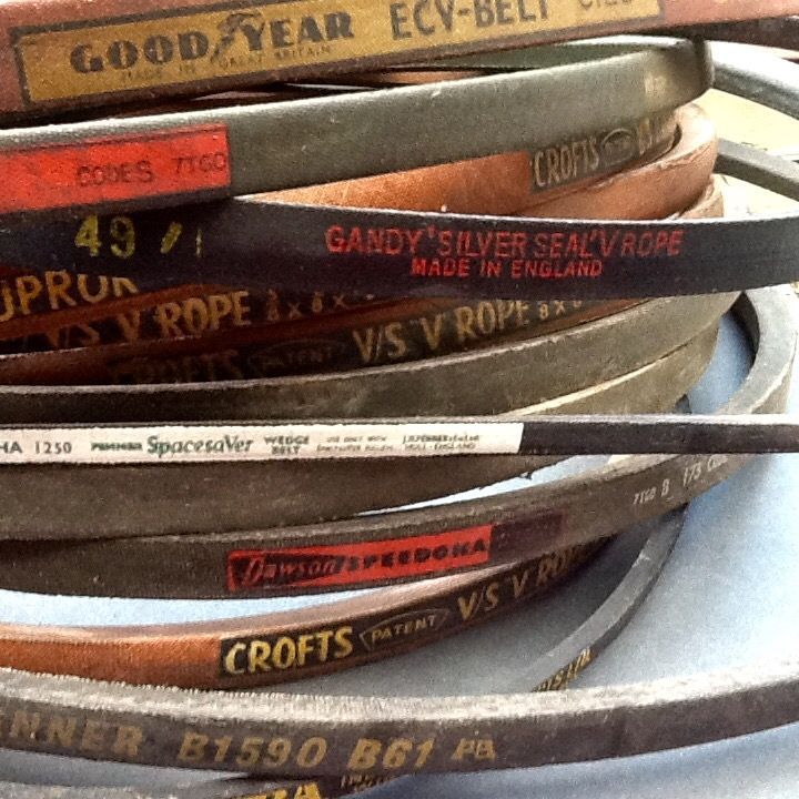 A bunch of belts are stacked on top of each other