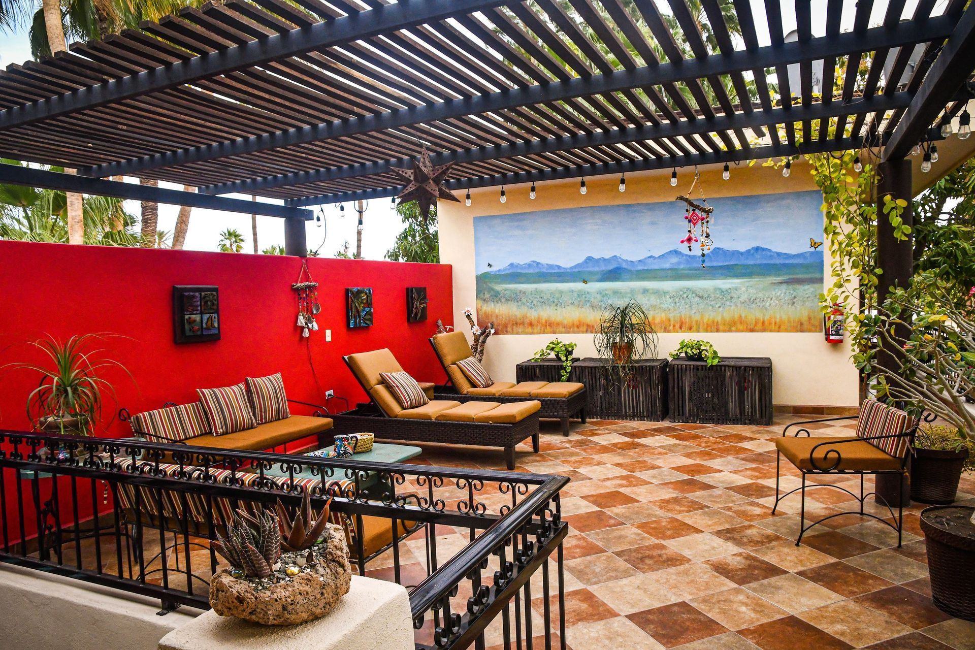 A patio with chairs , a table and a fire extinguisher.