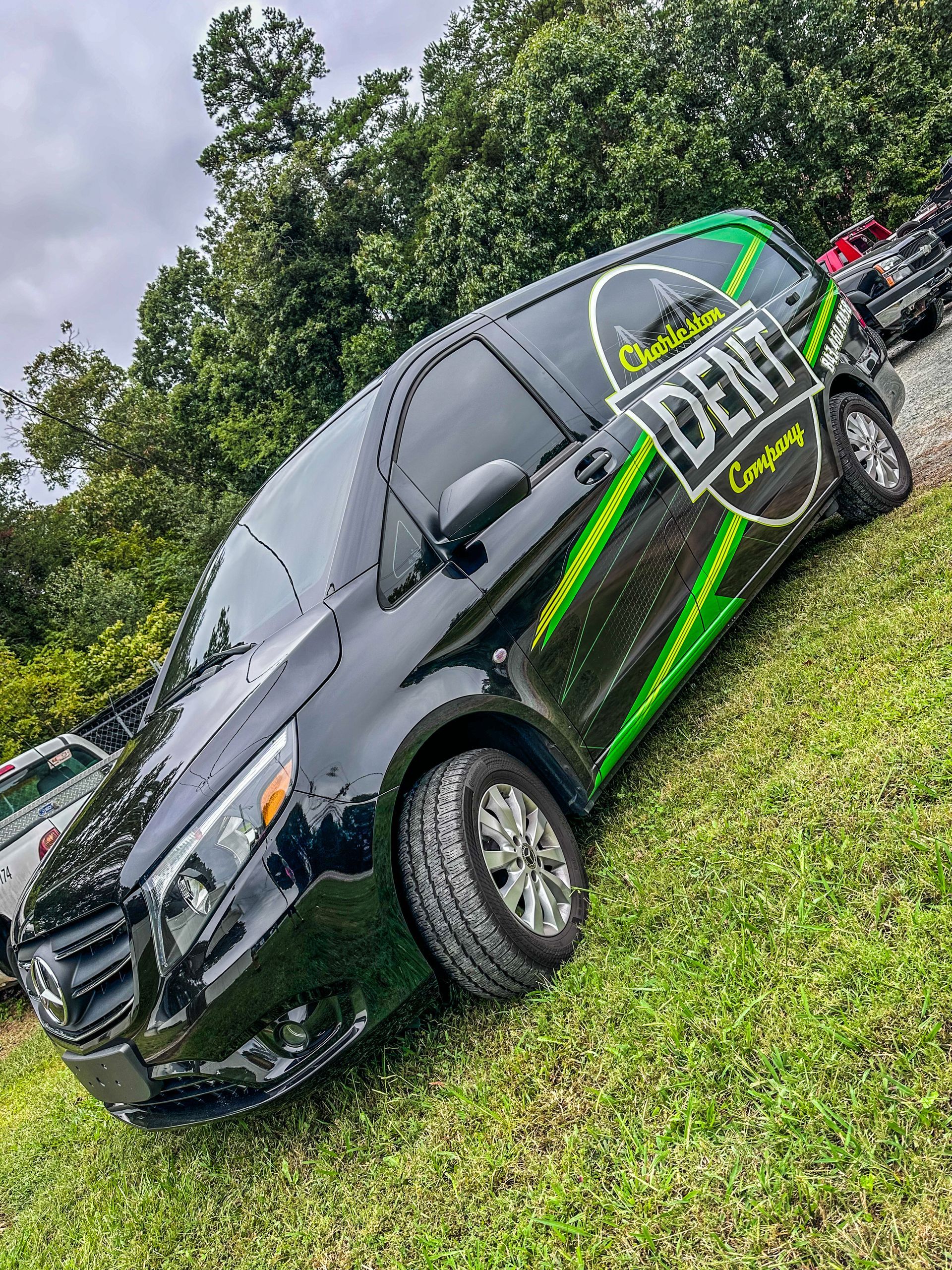 front of a Black Mercedes Metris van clearly displaying Charleston Dent Company logo 