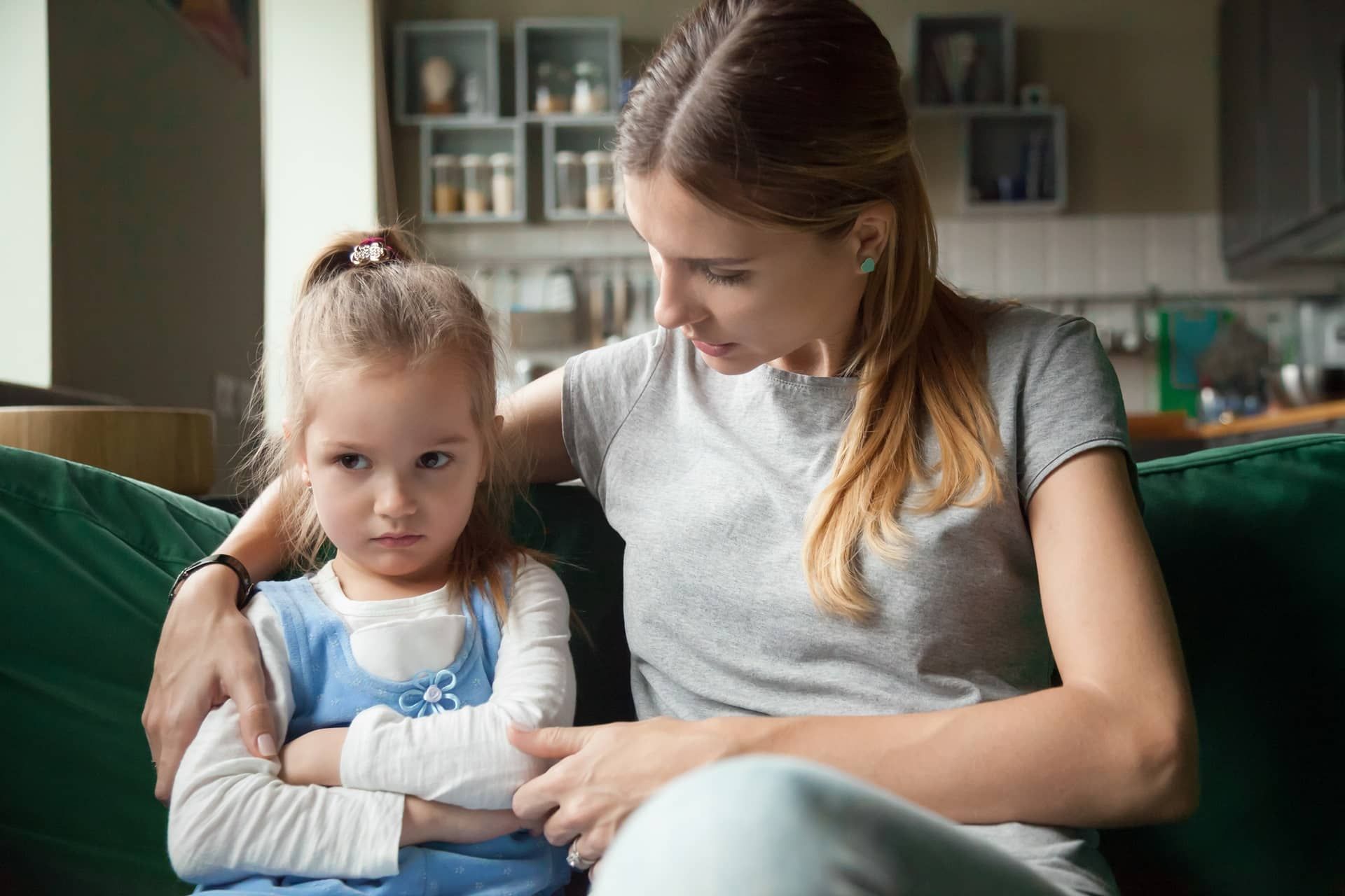 Unhappy child being comforted by mother