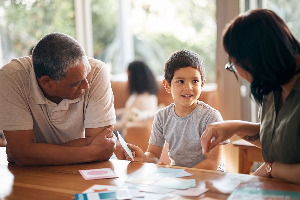 A man and a woman are sitting at a table with a child.