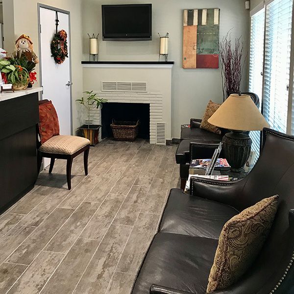A living room with a couch and chairs and a fireplace