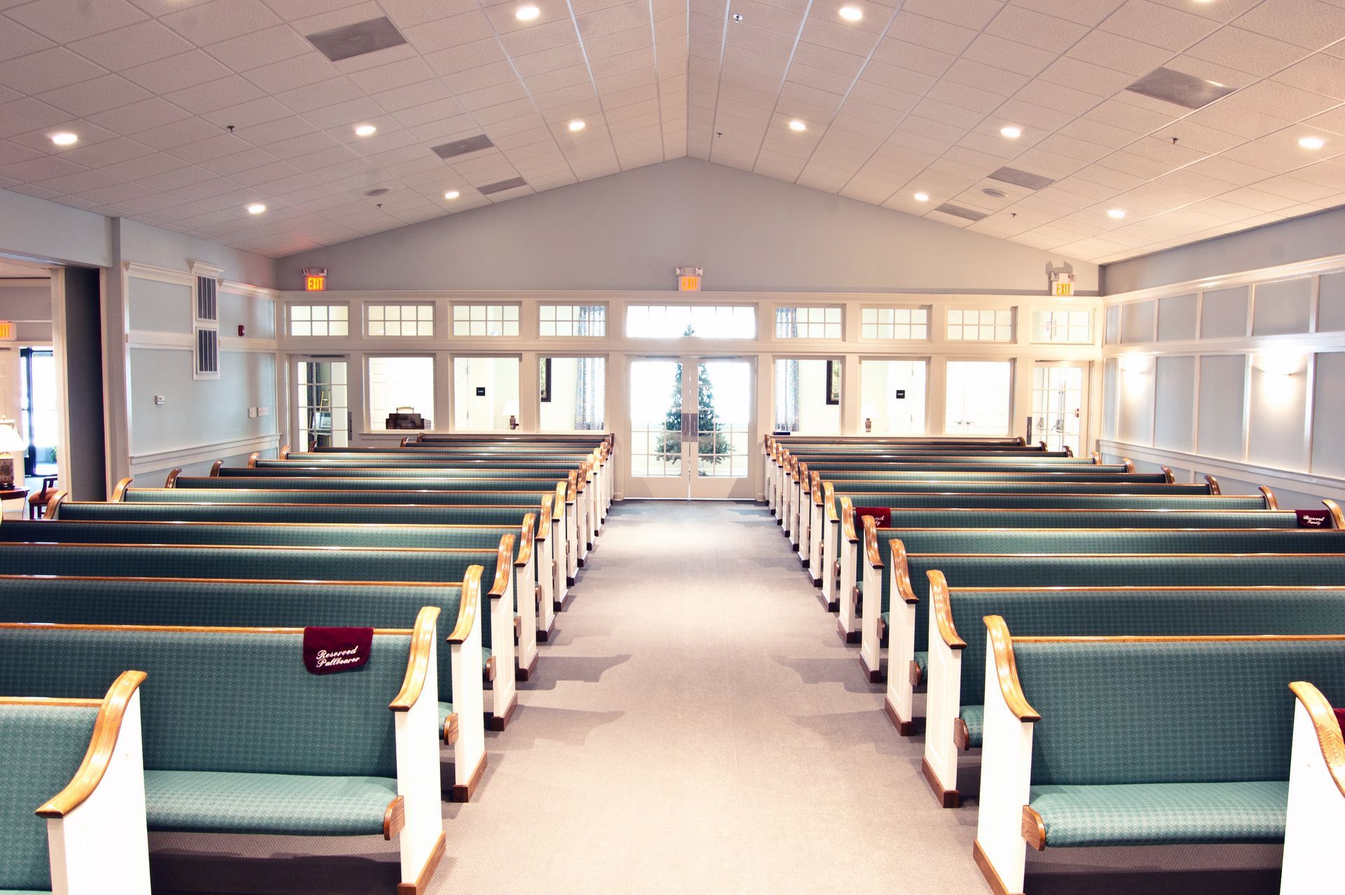 A man is standing in front of an open bible in a church.