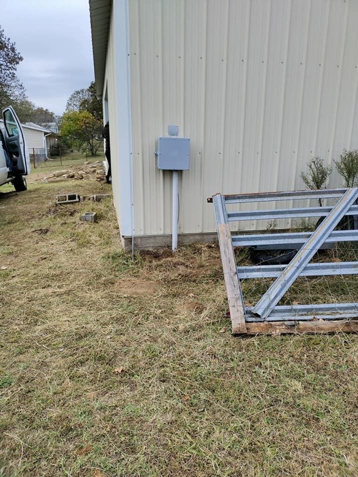 A white building with a metal gate in front of it.