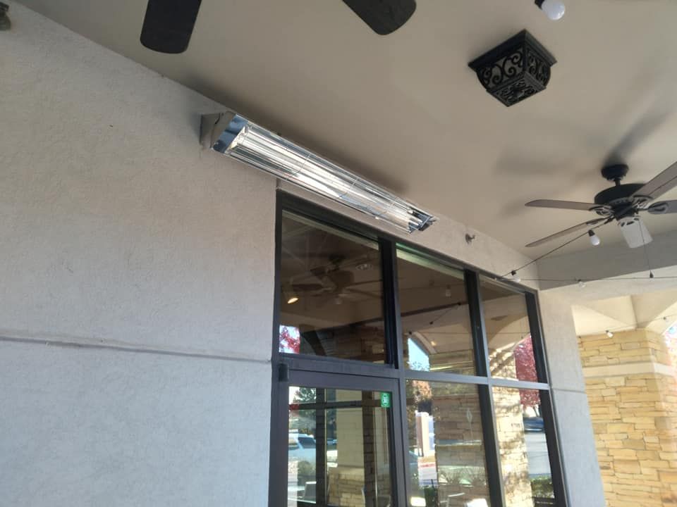 A ceiling fan is hanging from the ceiling above a window