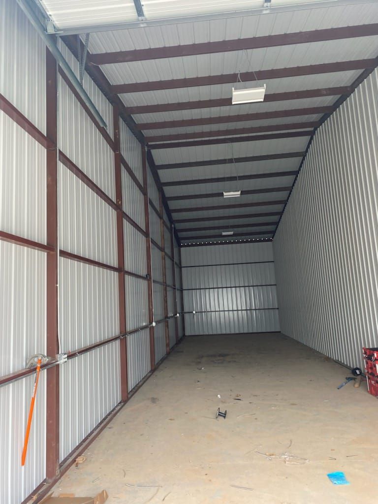 A large empty warehouse with a metal roof and walls.