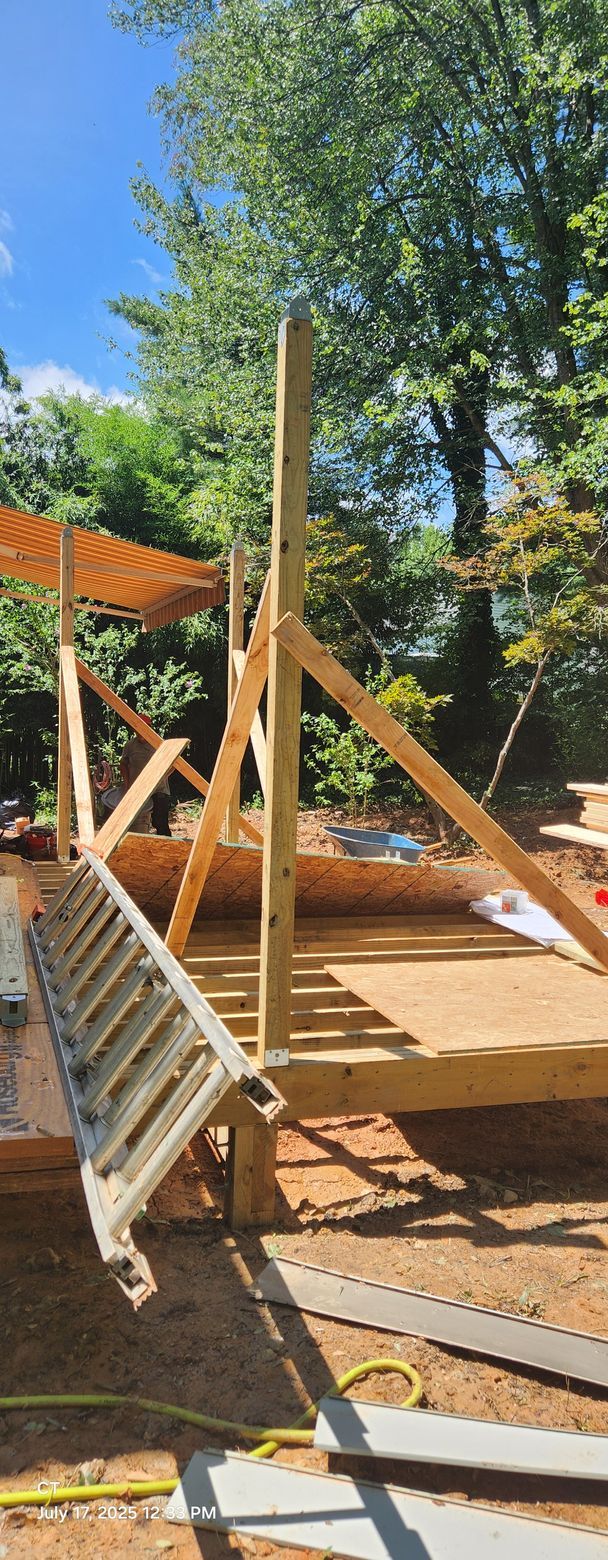 A ladder is sitting on top of a wooden structure under construction.