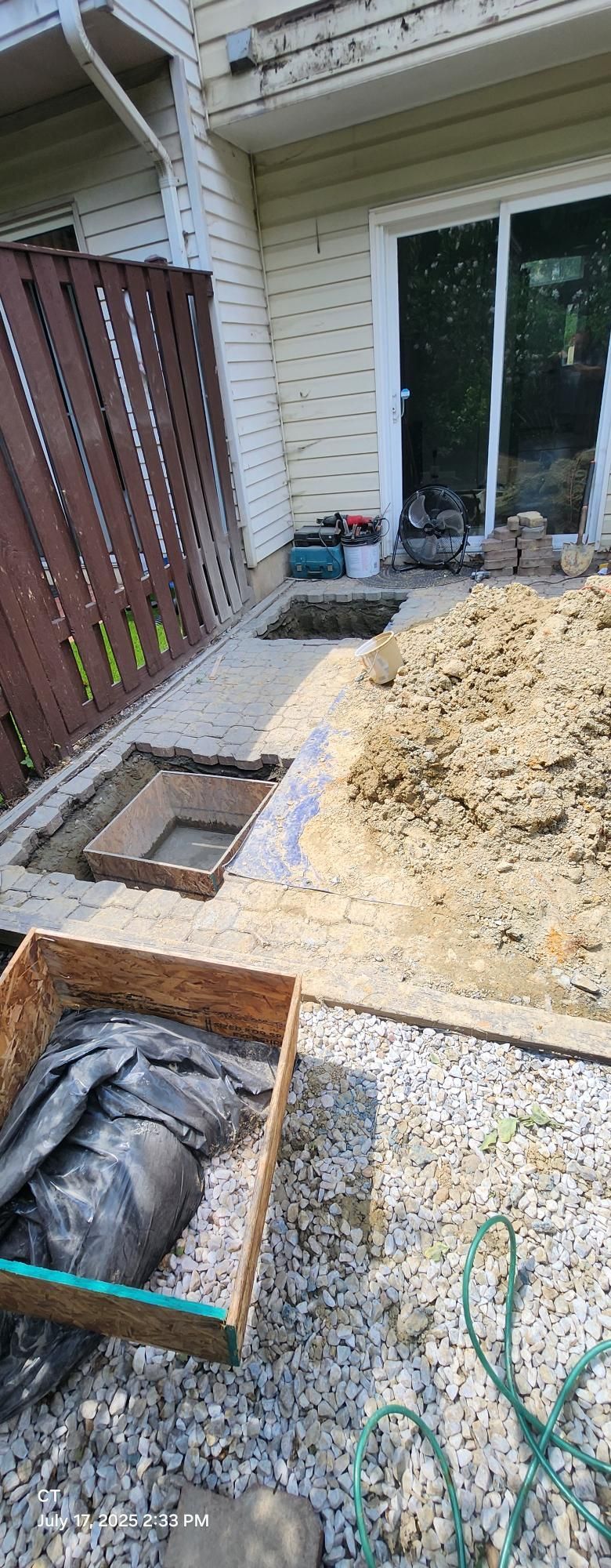 A pile of dirt is sitting in front of a house.