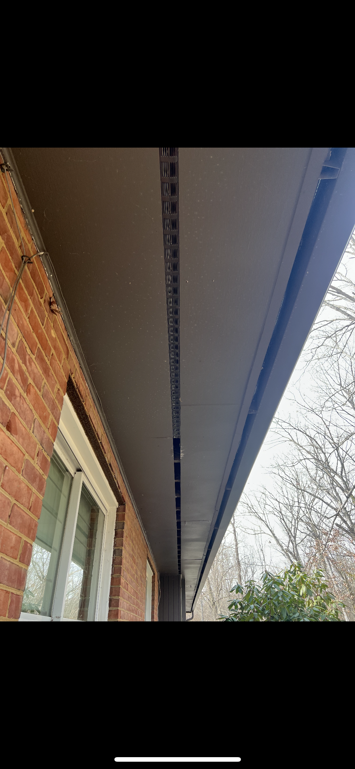 A picture of the roof of a house with a gutter.