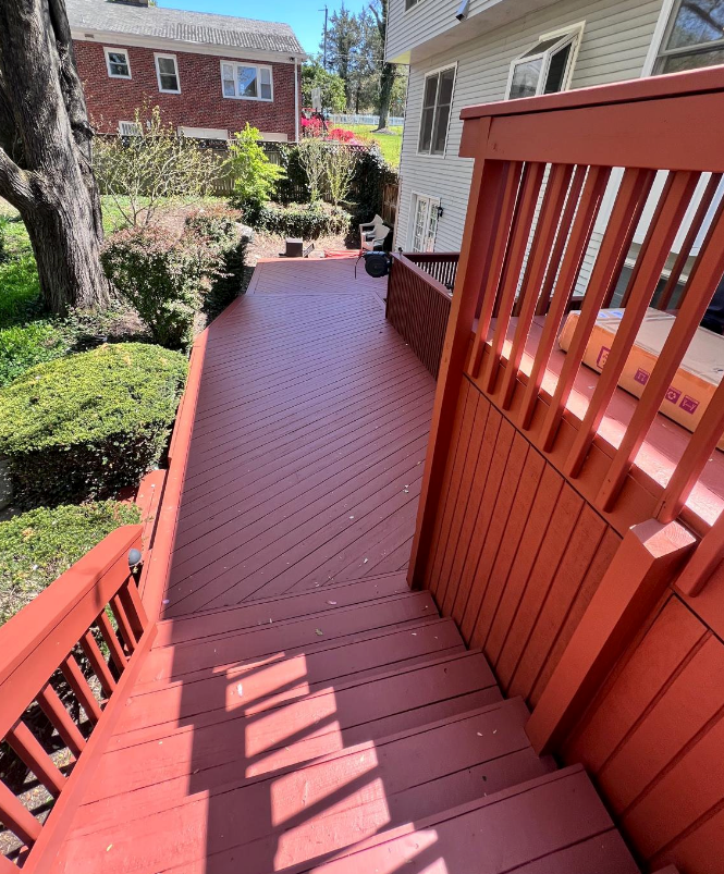 A red deck with stairs leading up to it