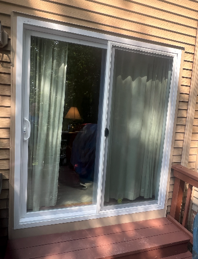 A sliding glass door is open to a living room.