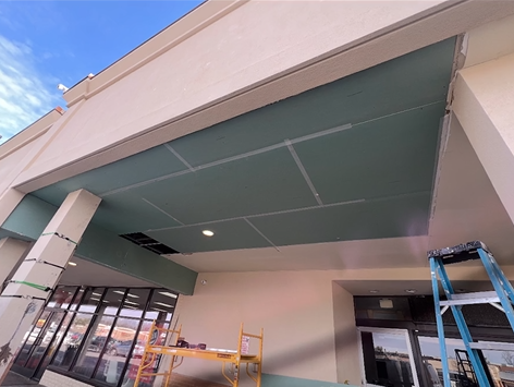 A ceiling is being installed on the side of a building.
