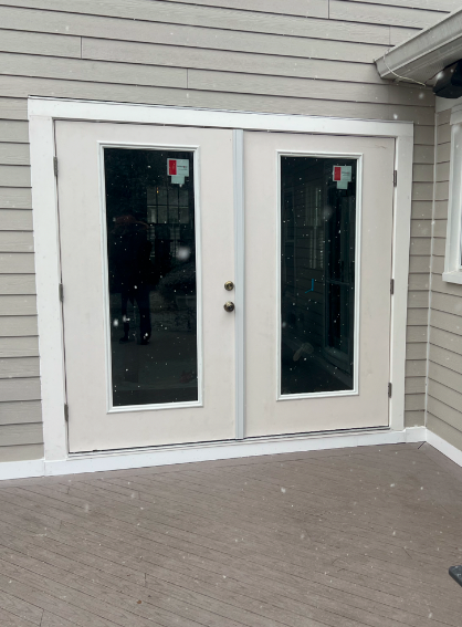 A pair of french doors on the side of a house