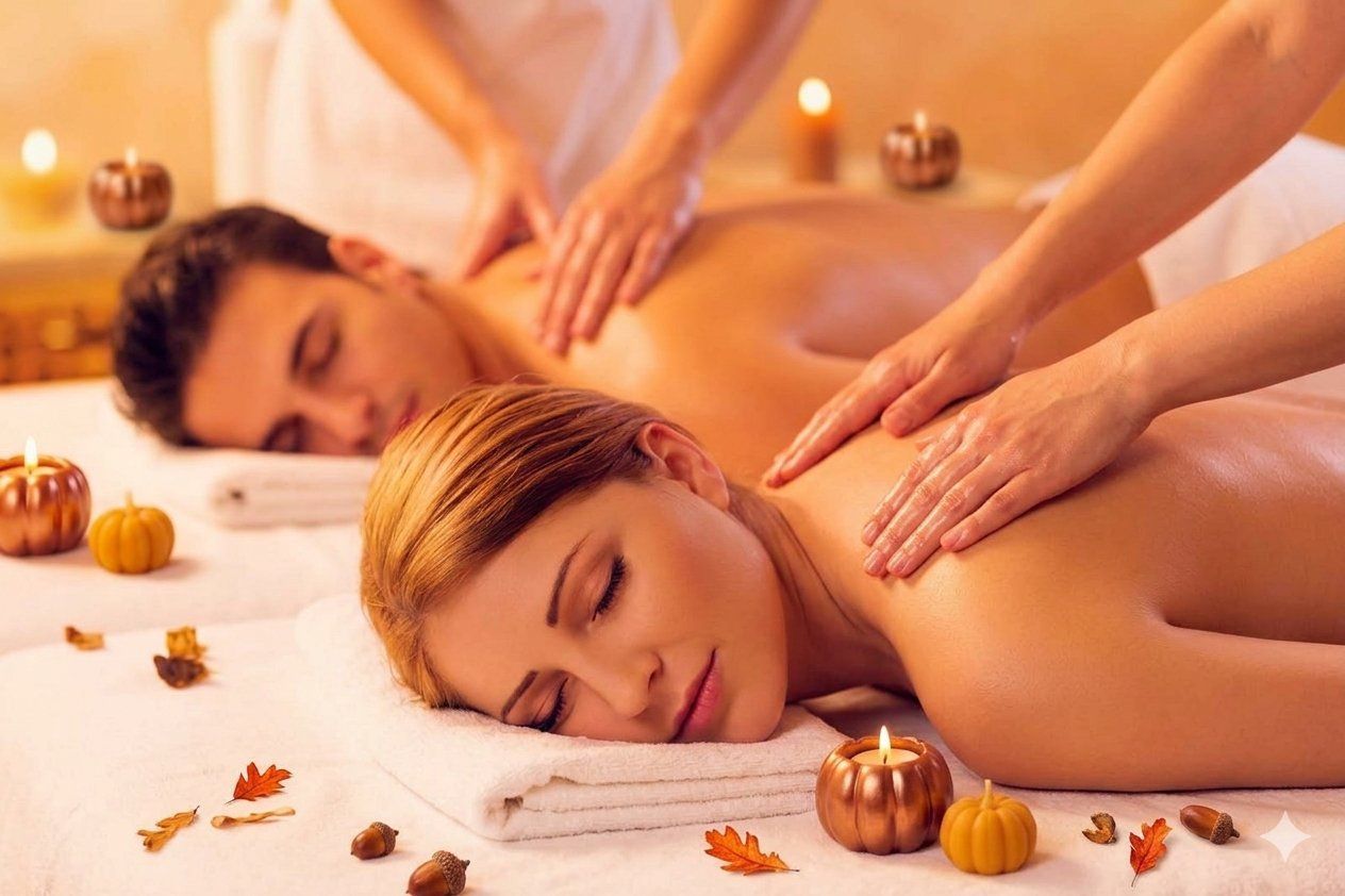 Two people receiving a relaxing spa massage with candles and warm orange lighting