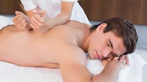 Person getting a back massage while lying face down on a massage table