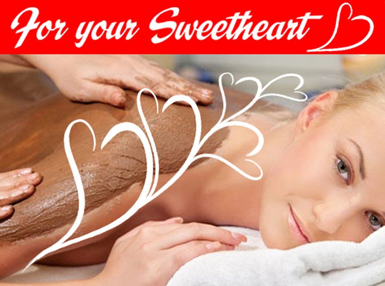 Woman receiving back massage with heart graphics and “For your Sweetheart” text on red banner