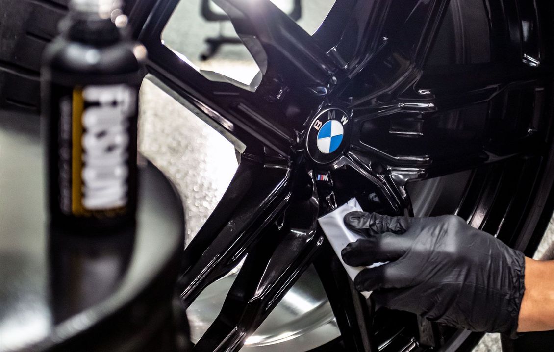 EuroCars Detail technician applying ceramic coating to luxury vehicle
