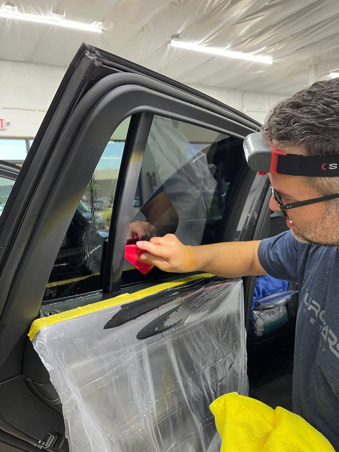 Window tinting service by technician.