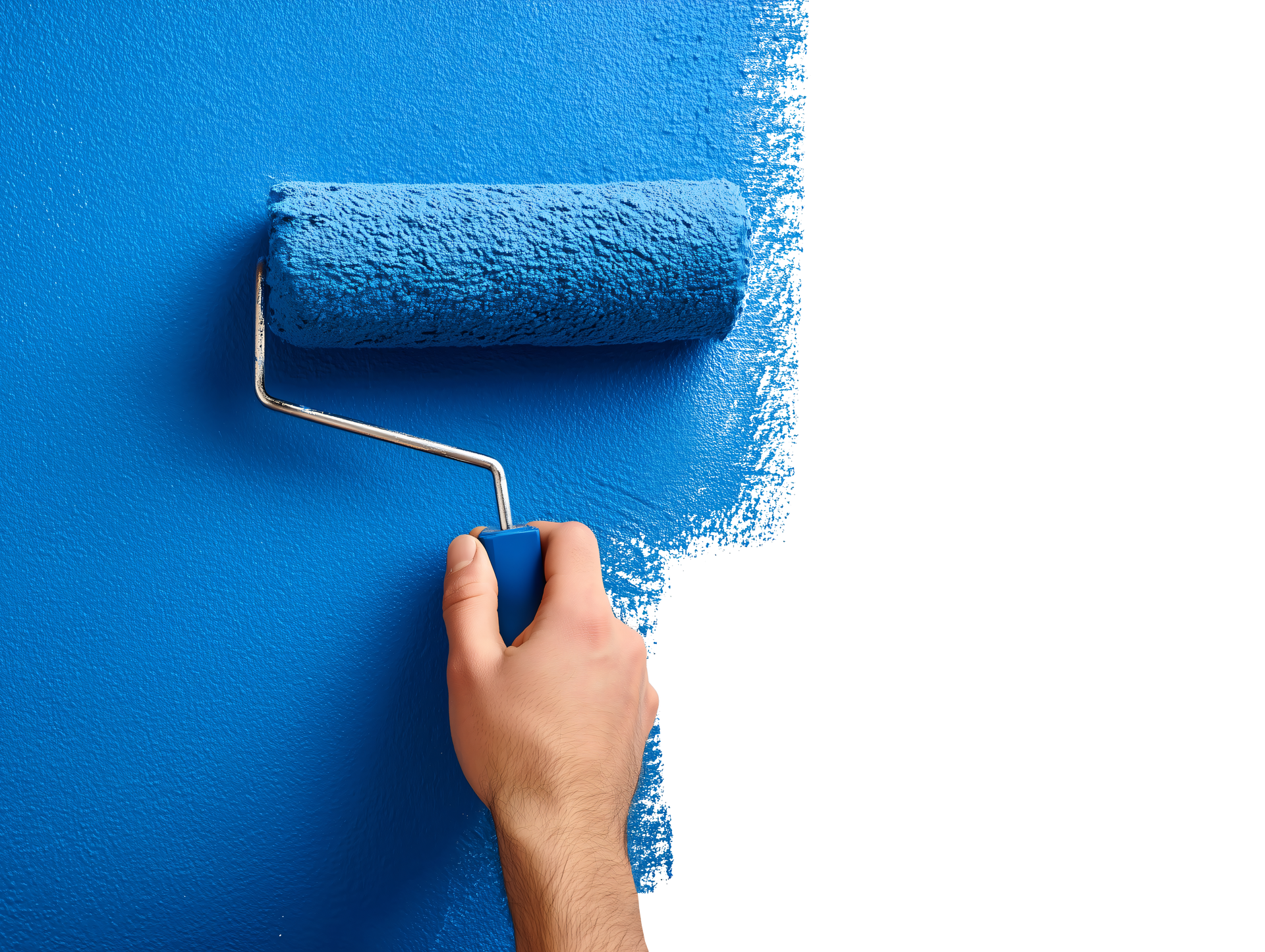 Hand using a blue paint roller to paint a wall blue.