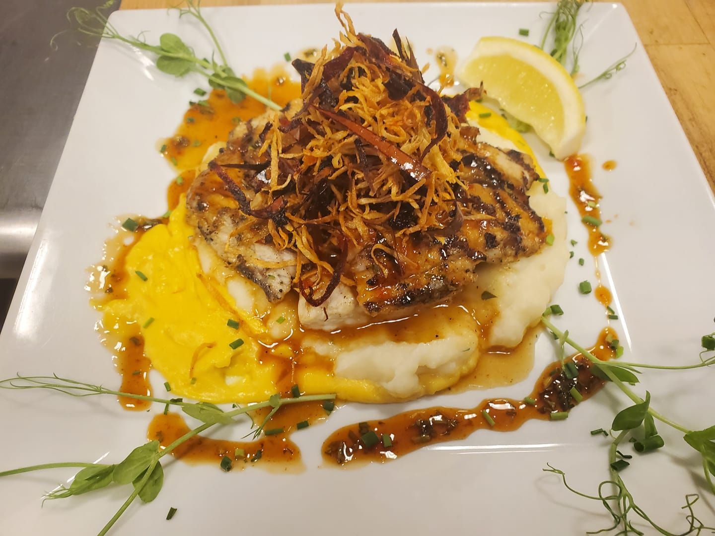 A plate of food with mashed potatoes and meat on a table