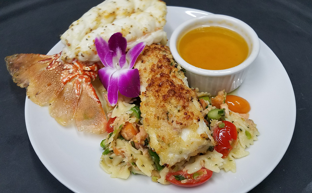 A plate of food with a purple flower on it