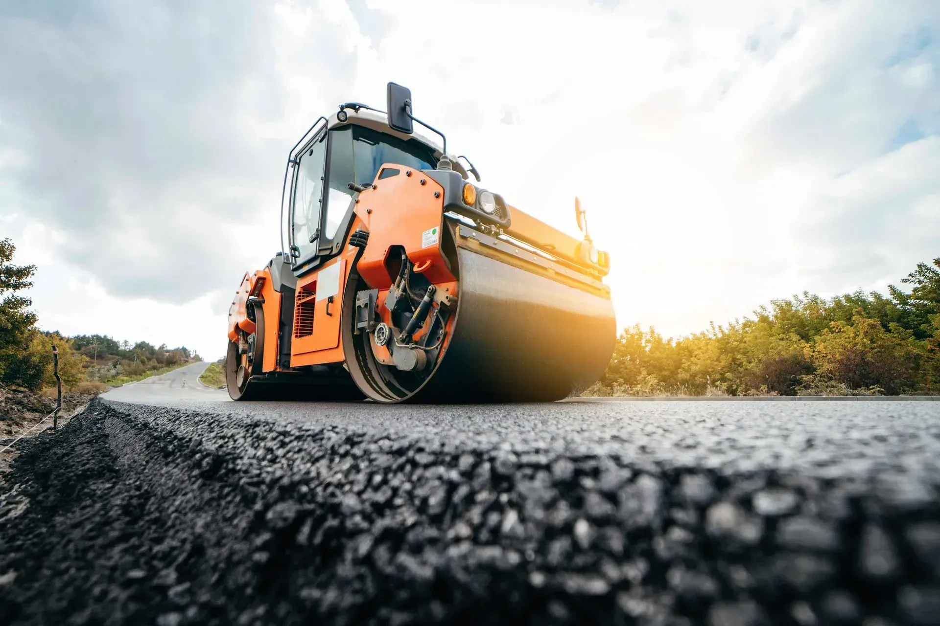 A roller is rolling asphalt on a road.