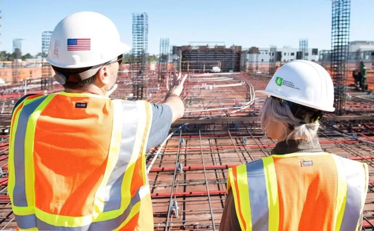 Professional general contractors managing commercial construction project and foundation work