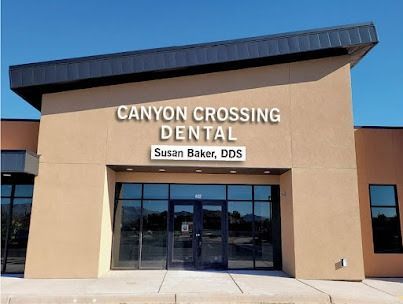Canyon Crossing Dental storefront with tan facade, dark awning, and glass entrance under a blue sky