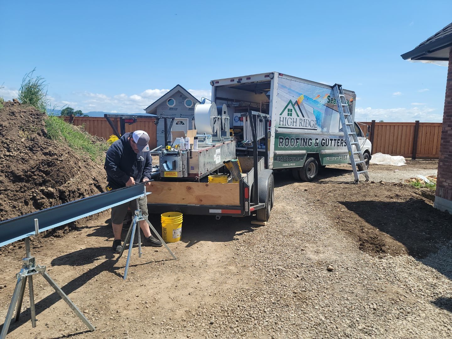 Worker situating gutters to be put on a home