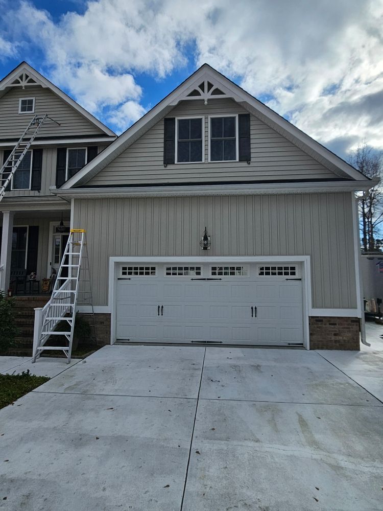 A light-colored suburban house with a two-car garage