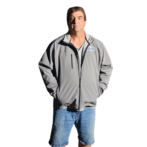 A person wearing a grey zip-up jacket and blue denim shorts stands against a white background.