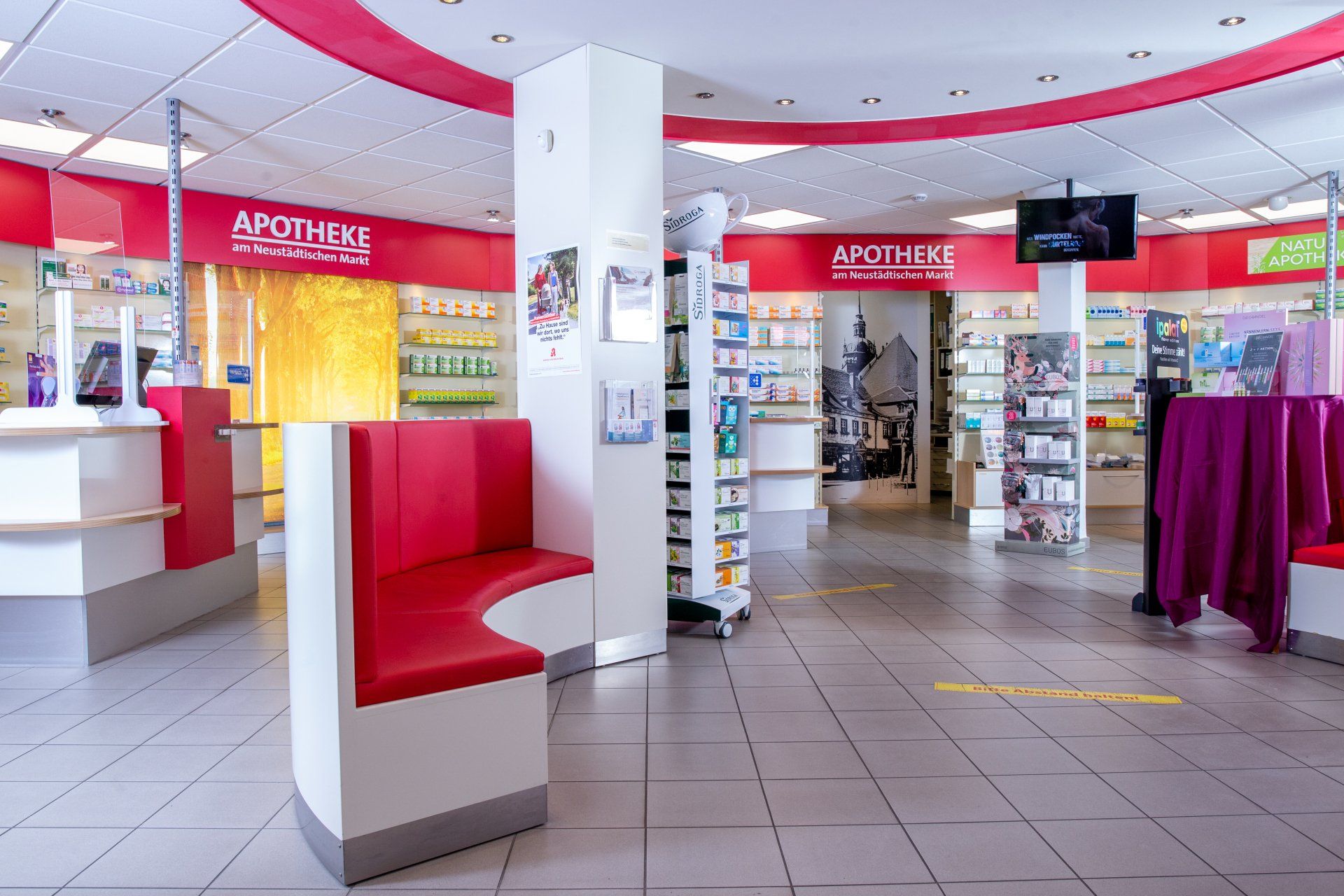 Eine Apotheke mit einer roten Bank in der Mitte des Raumes.