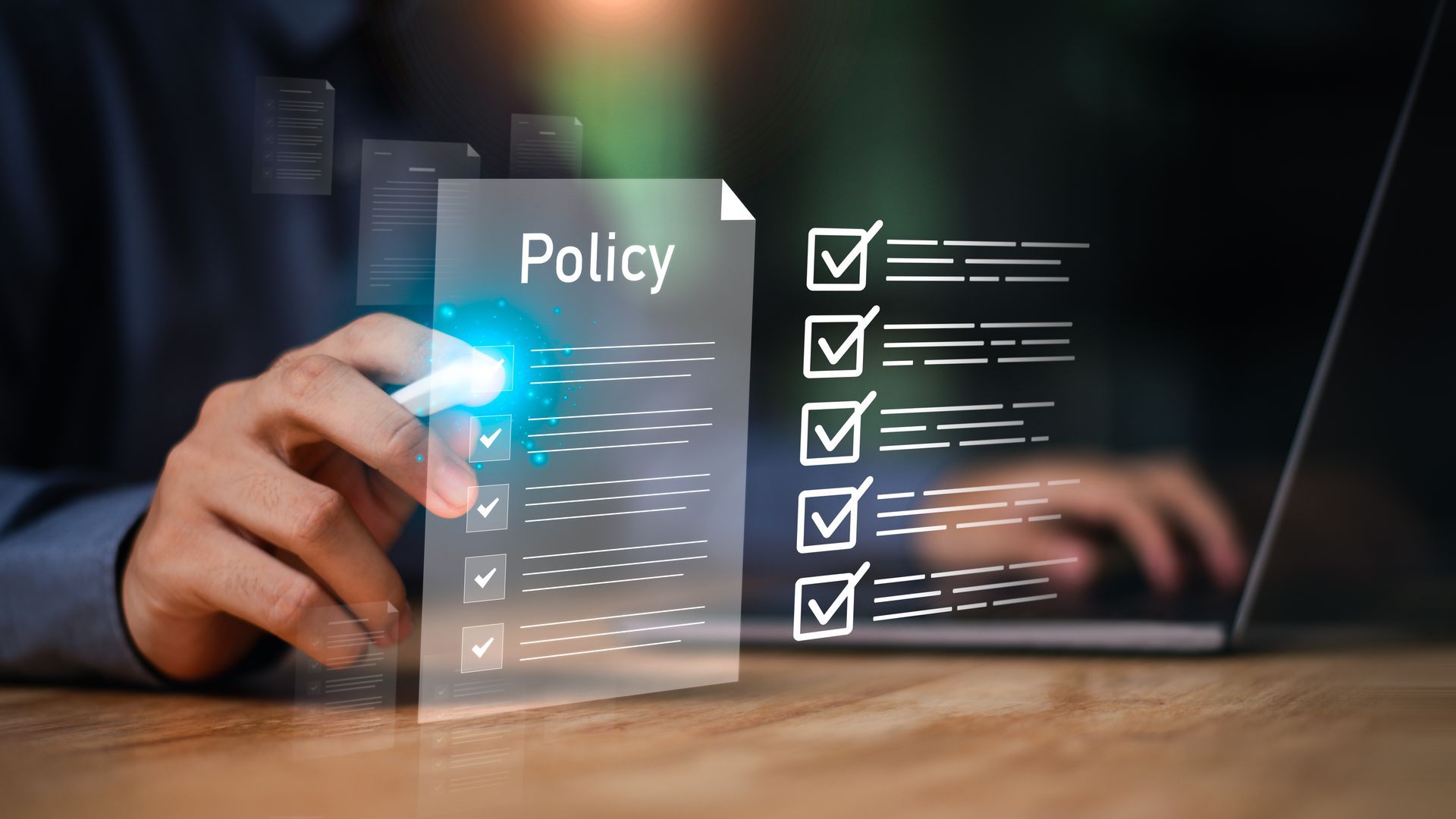 Hand touching a digital “Policy” checklist interface with glowing blue icons on a desk screen